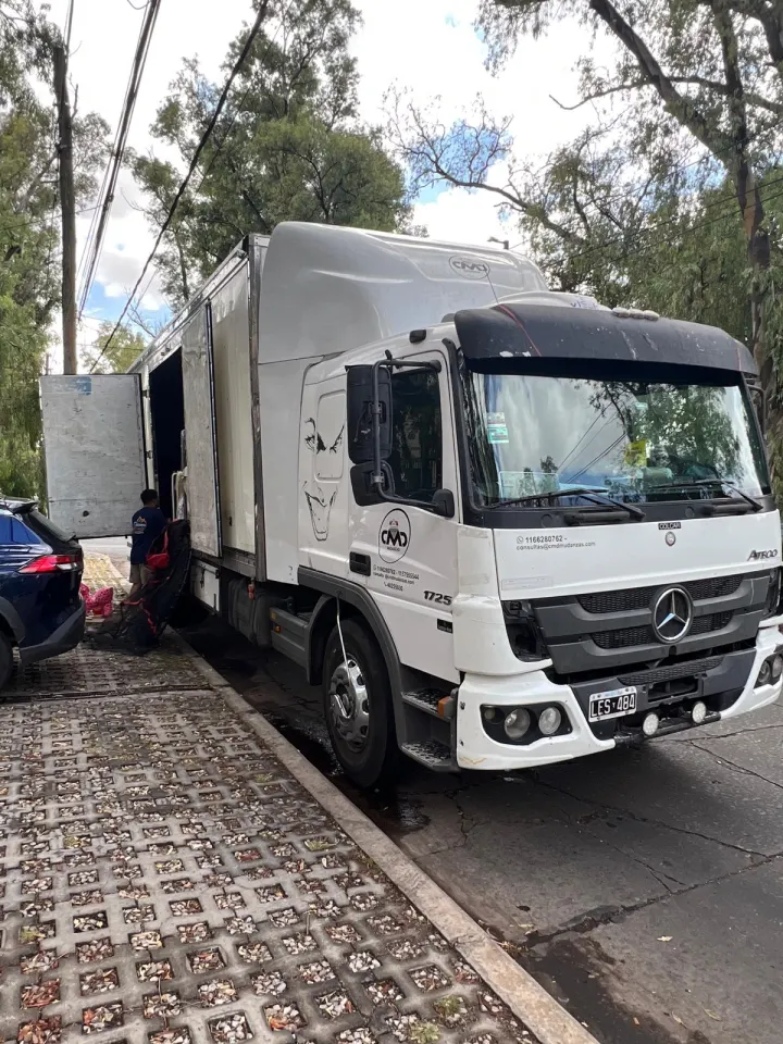 Camión de Mi Mudanza estacionado frente a una casa arbolada