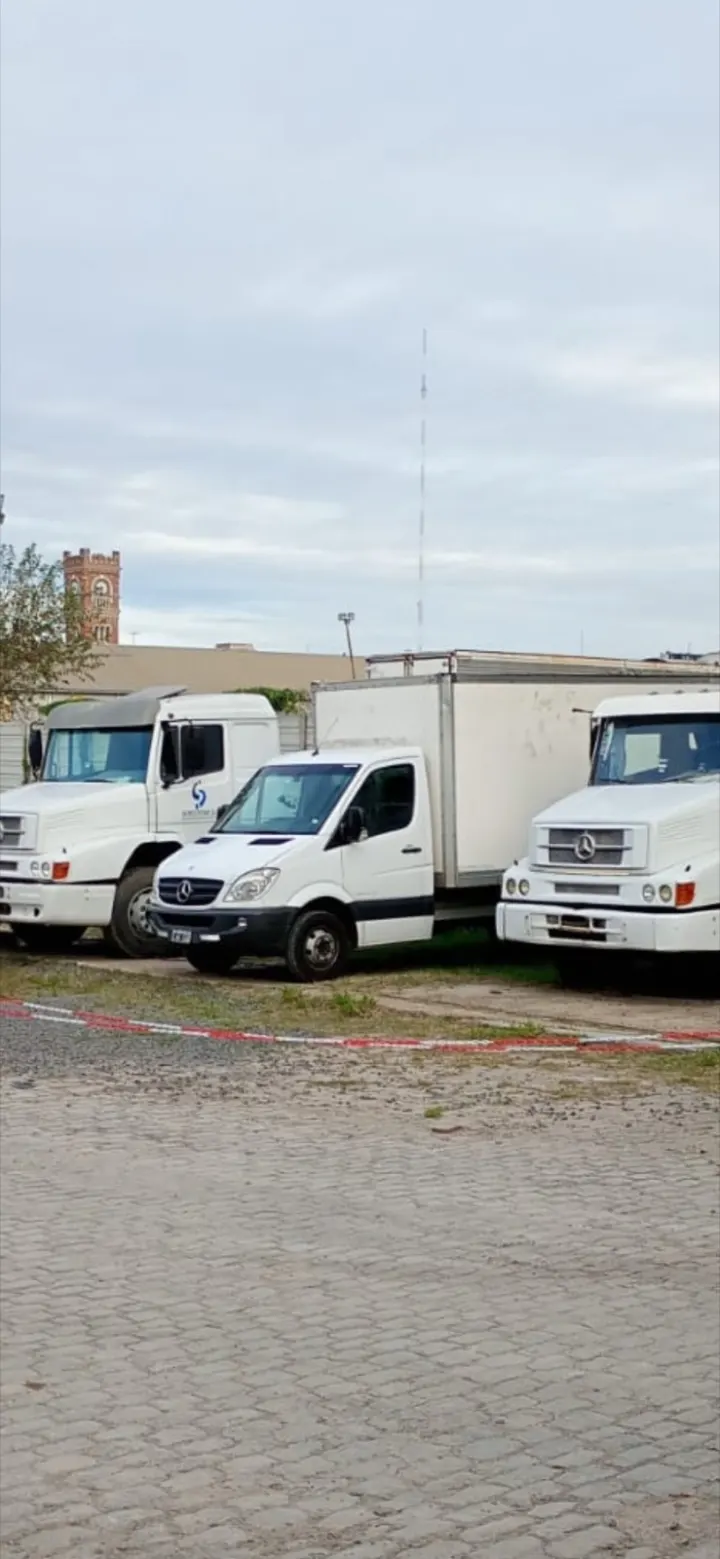 Tres camiones de la flota de Mi Mudanza en la playa de estacionamiento